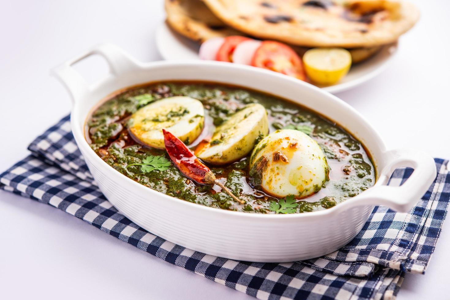 Spinach egg curry is an Indian non vegetarian dish made using palak gravy with eggs photo