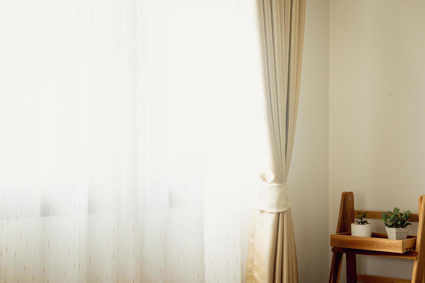 beautiful white curtain scene windows and curtain walls The light and shadow of the evening weather Warm colors that shine through silk curtains or curtains inside. photo