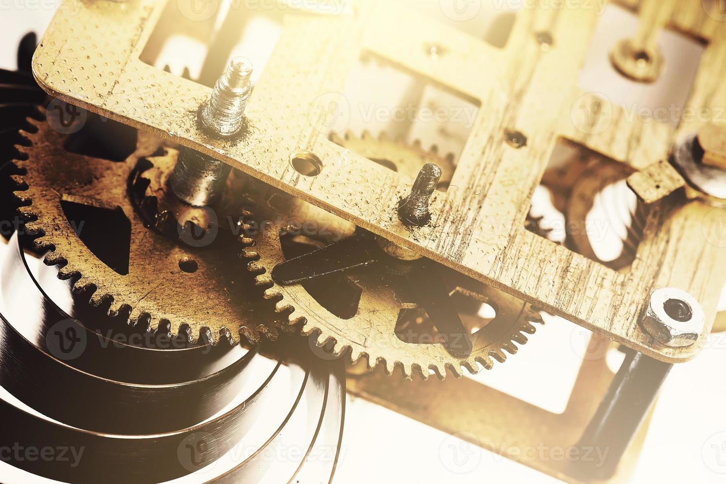 Old brass clock mechanism with gears photo