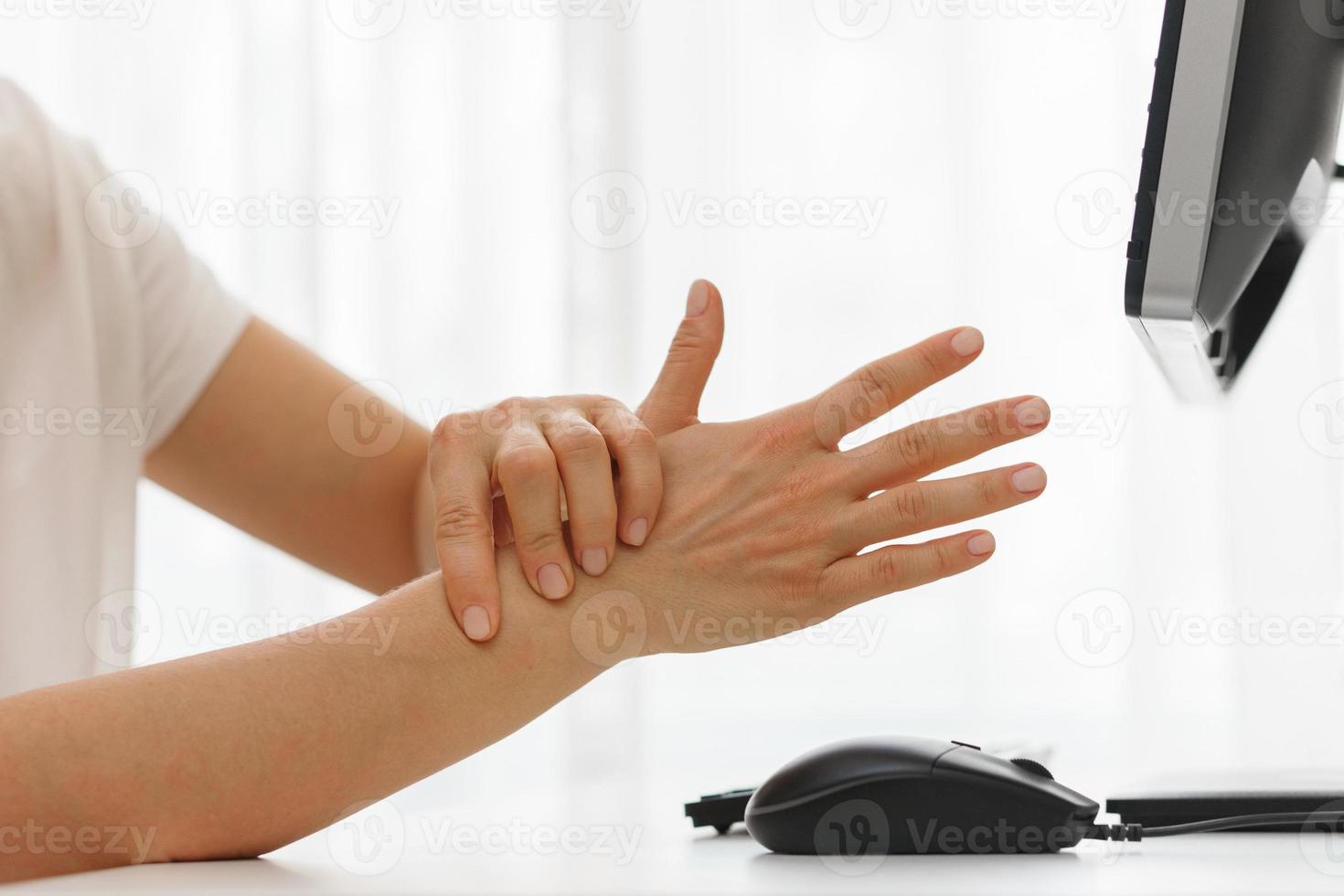 Female hands with a pain in the wrist because of carpal tunnel syndrome photo