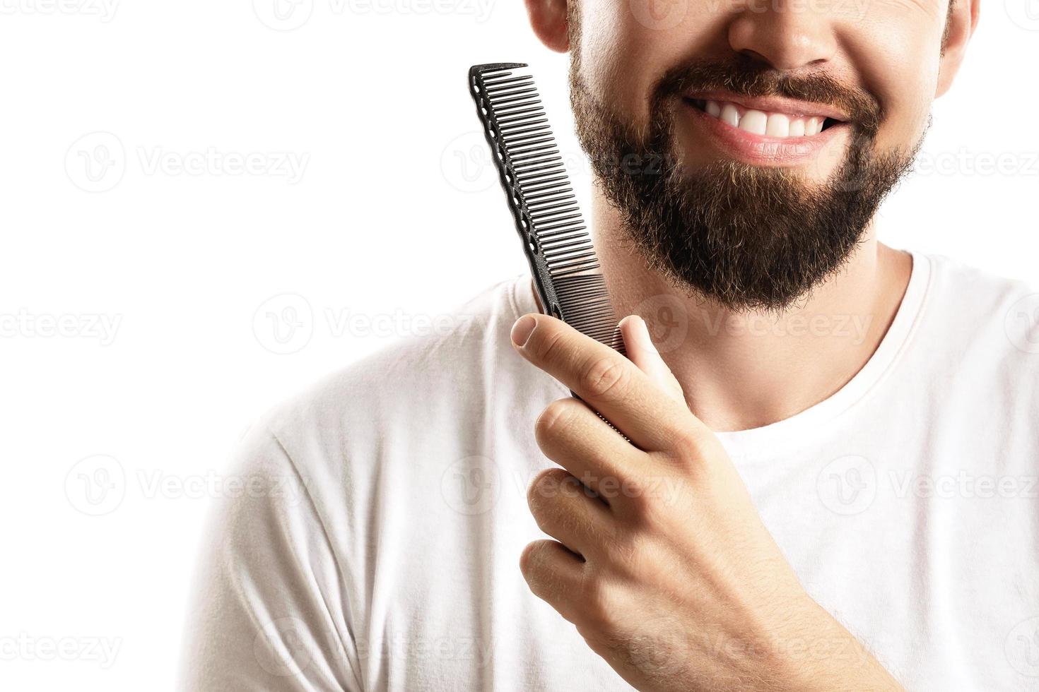 Man combing his beard on white background photo