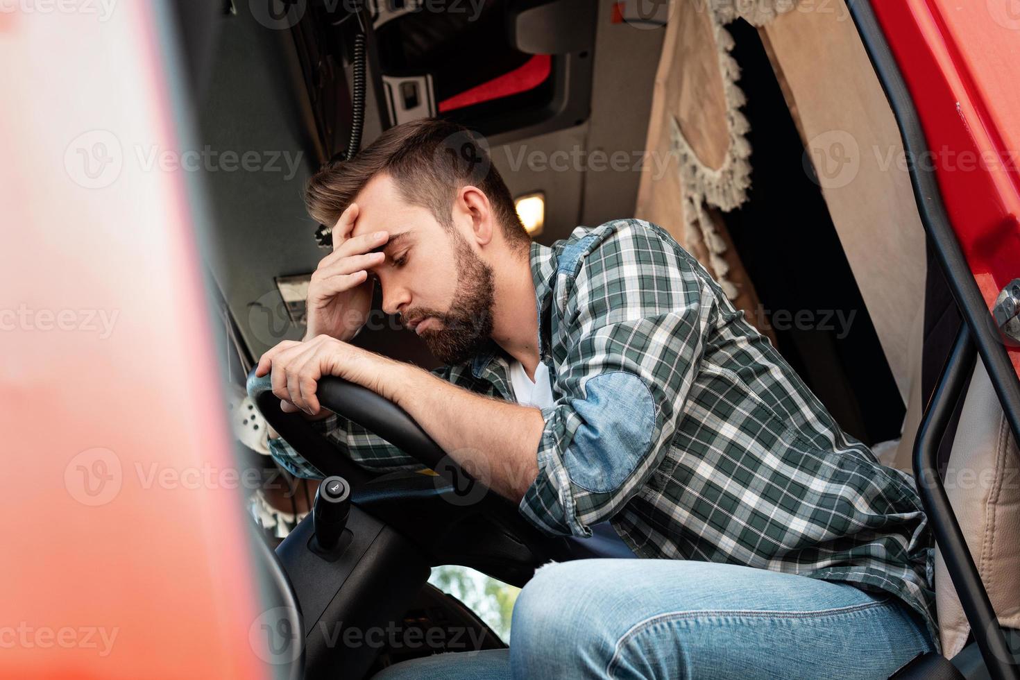 Tired truck driver feeling sleepy and sick photo