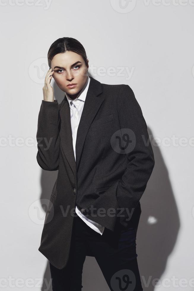 Fashionable studio portrait of young masculine woman photo