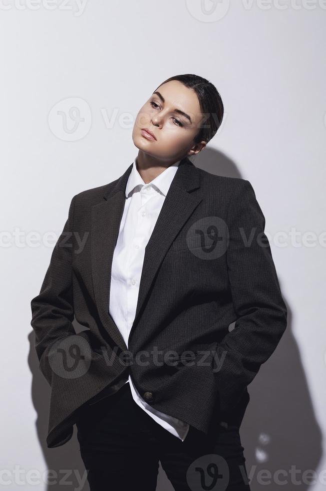 Fashionable studio portrait of young masculine woman photo