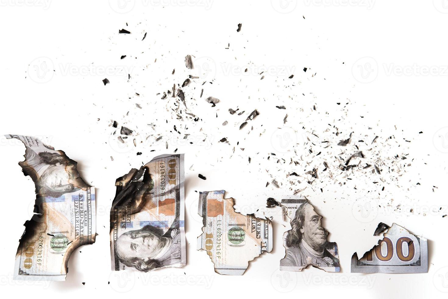 Remainings of a burnt out dollar bills reduced to ashes after a fire. photo