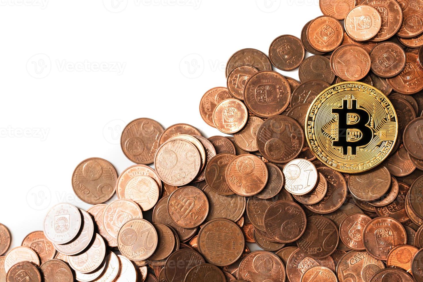 Shiny golden bitcoin on a pile of copper euro coins. photo