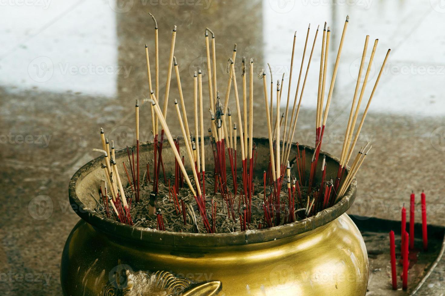 Traditional censer with smoldering sticks inside a buddhist temple. photo