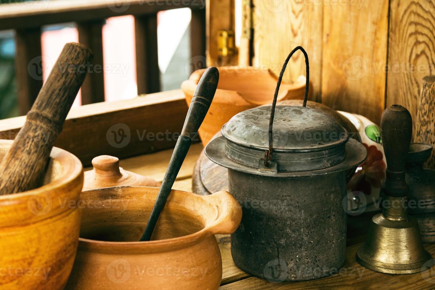 Closeup of handicraft made kitchenware on wooden table in rural house. photo