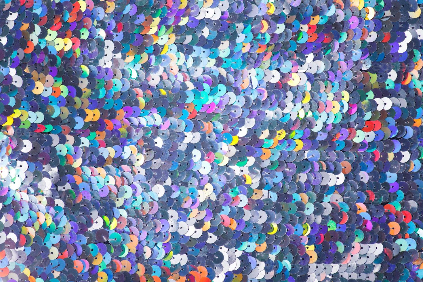 Closeup shot of a shiny multicolored sequin fabric. photo