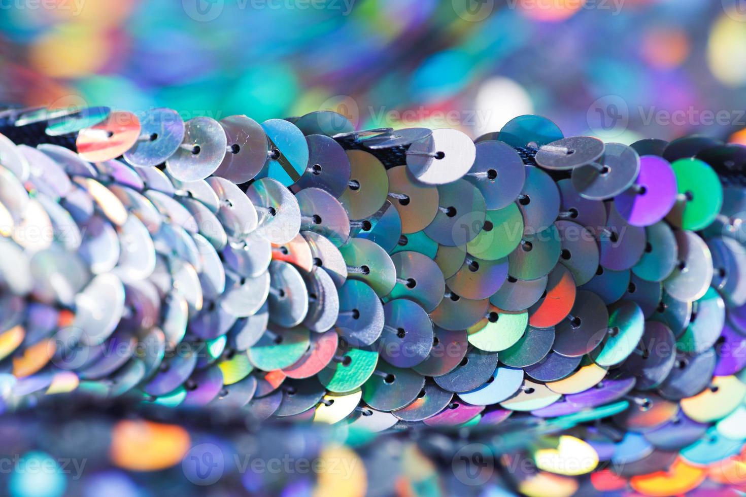 Closeup shot of a shiny multicolored sequin fabric. photo