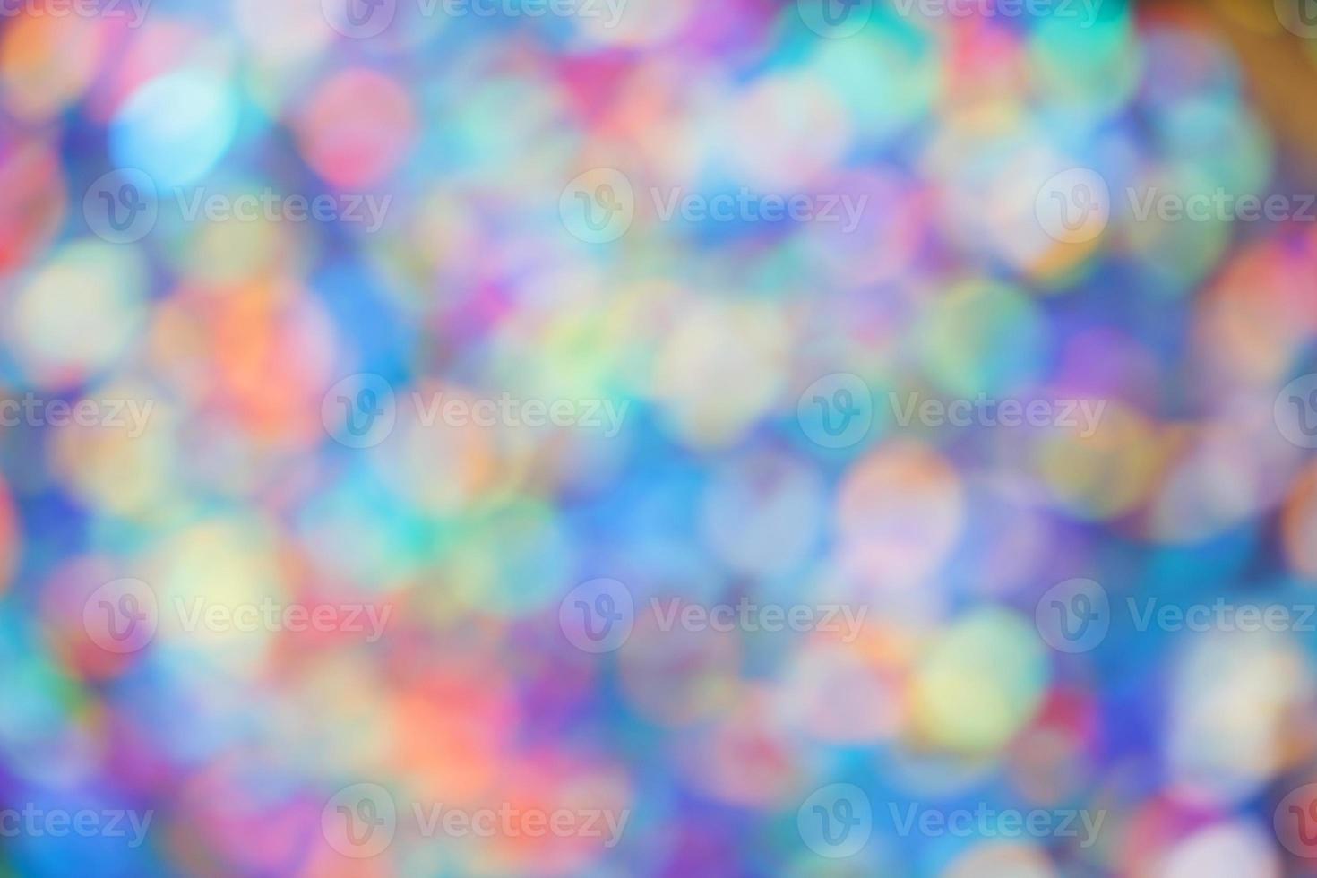 Bokeh de fondo abstracto de puntos de luz multicolores borrosos. foto