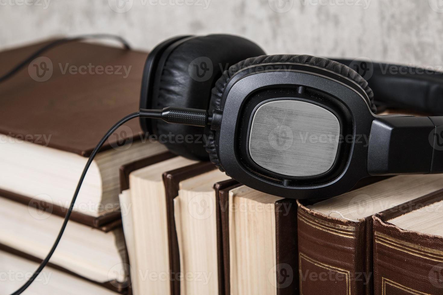 Audiobooks concept with books and headphone photo