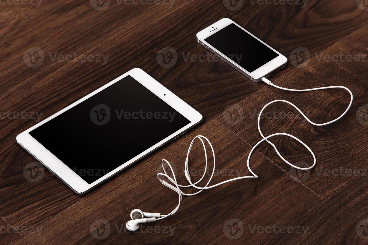 Smartphone and tablet with earphones photo