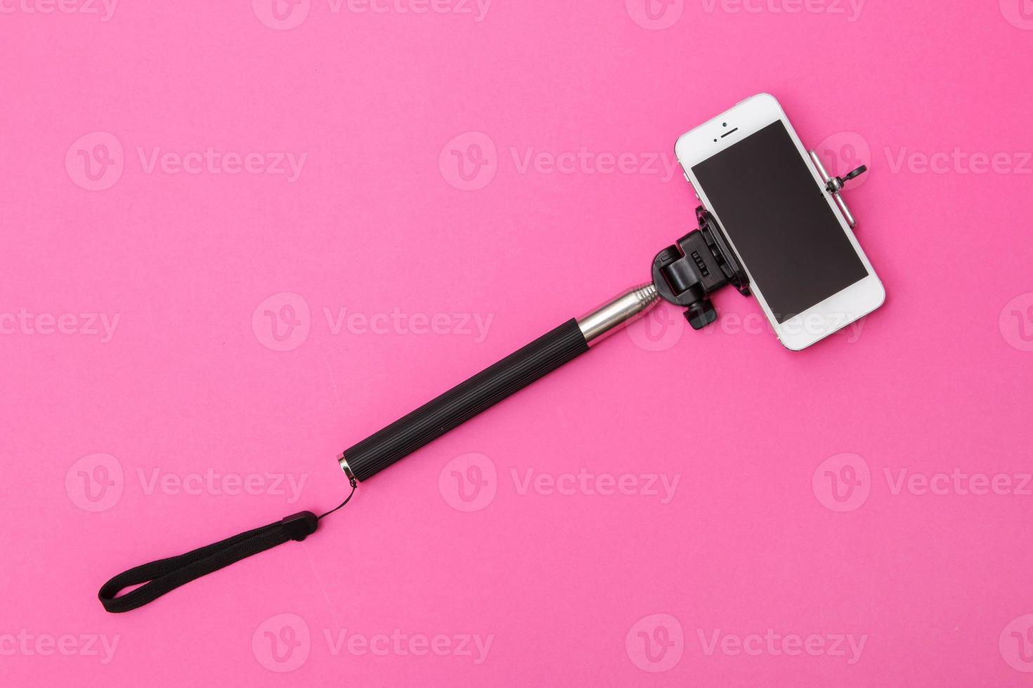 Selfie stick and white smart phone photo