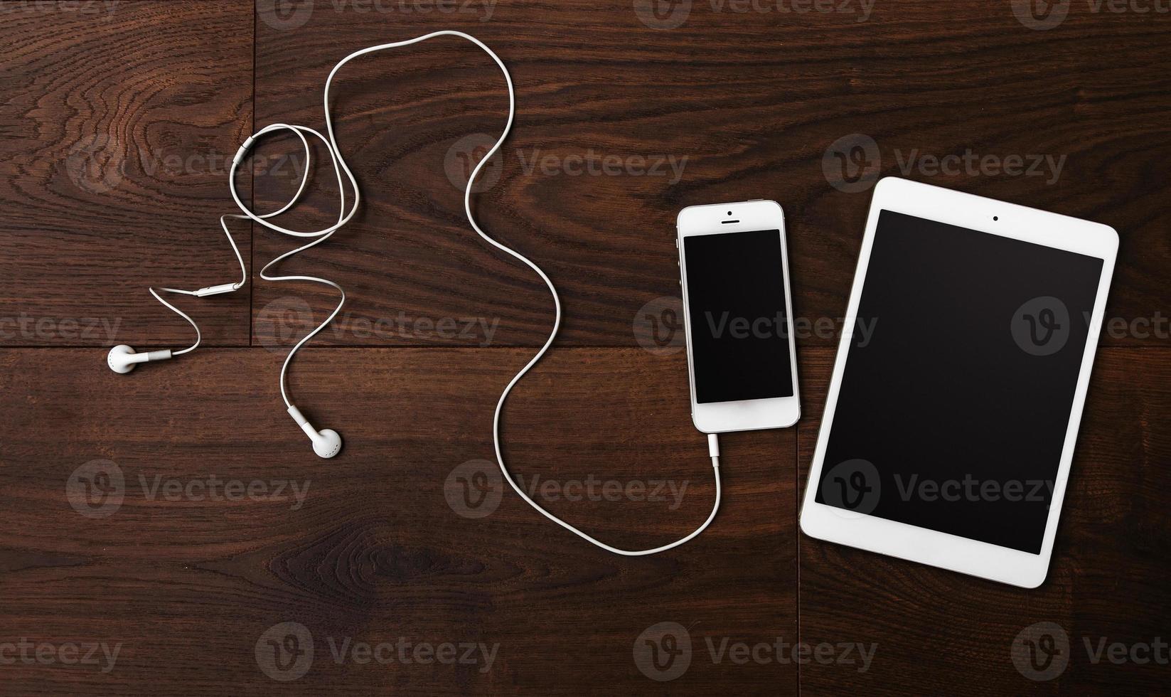 Smartphone and tablet with earphones photo