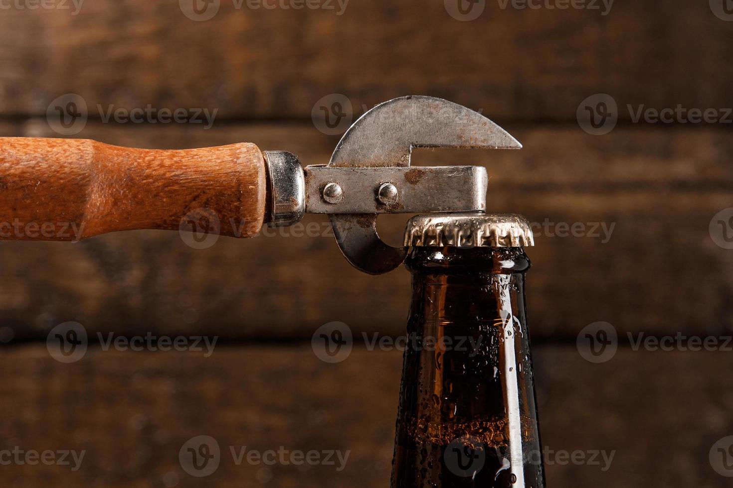 Bottle of beer and vintage opener photo