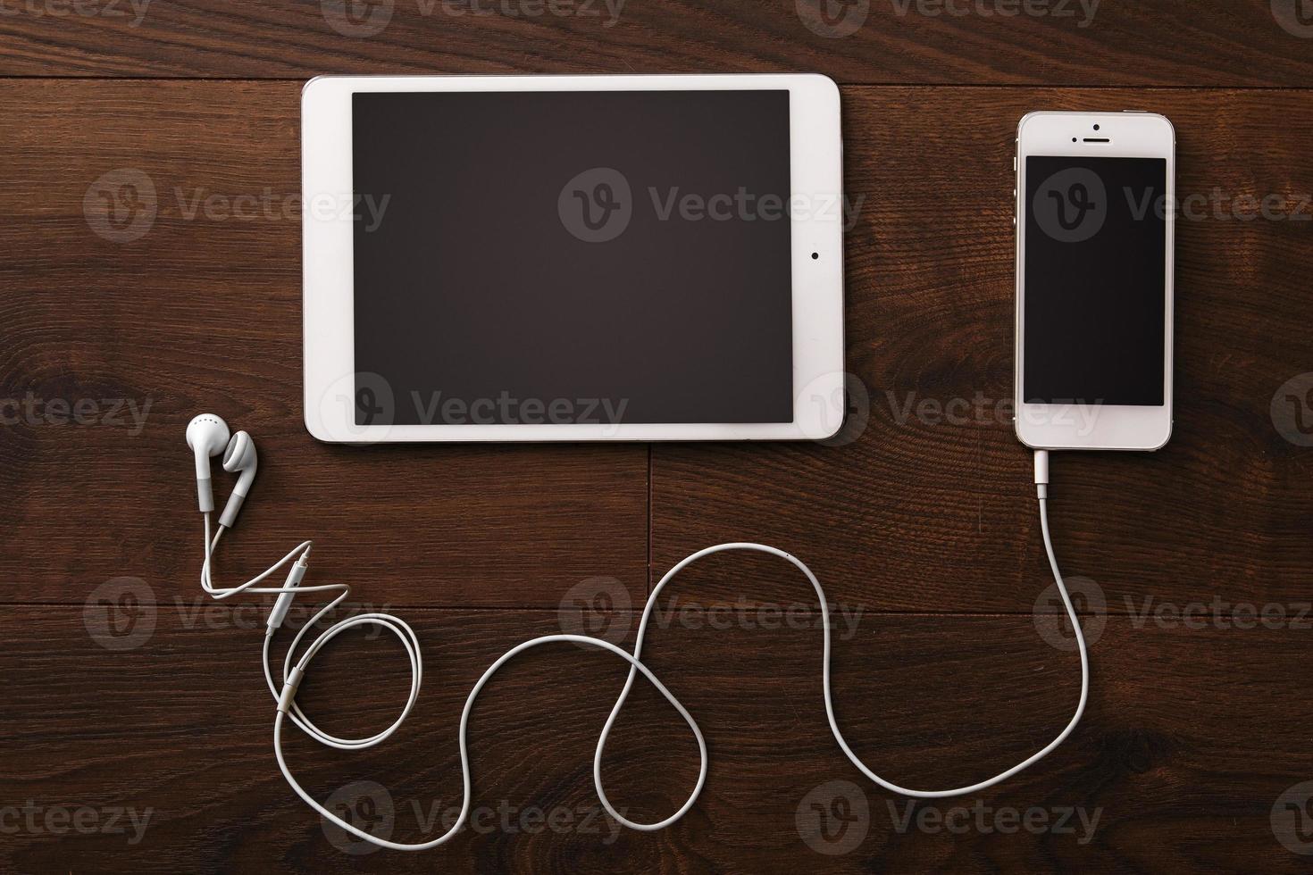 Smartphone and tablet with earphones photo