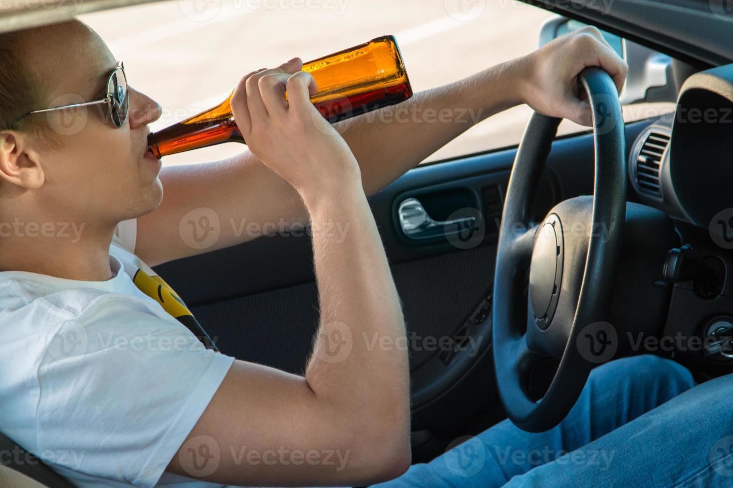 Man is drinking beer in his car photo