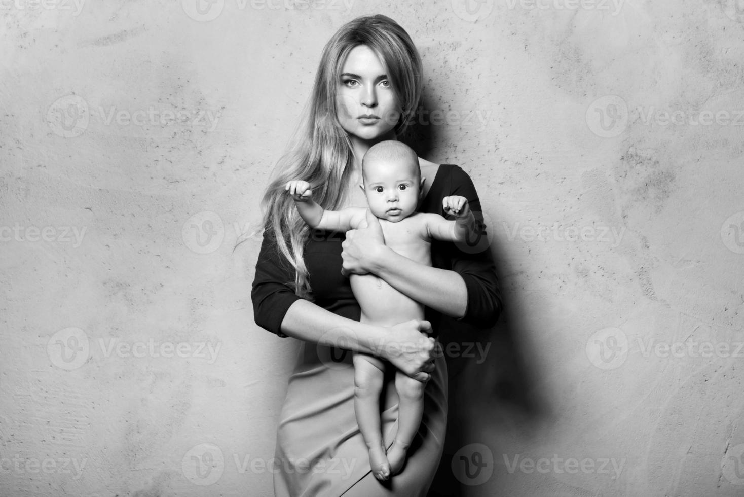 Beautiful well dressed and luxury mother with her cute baby boy photo