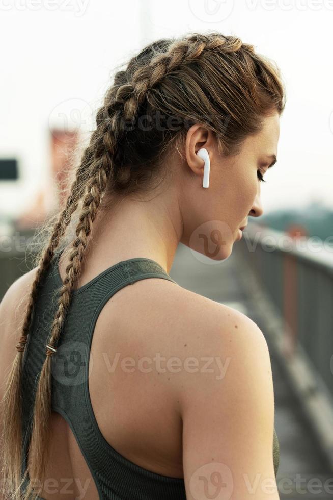 Woman athlete during her outdoor fitness workout photo