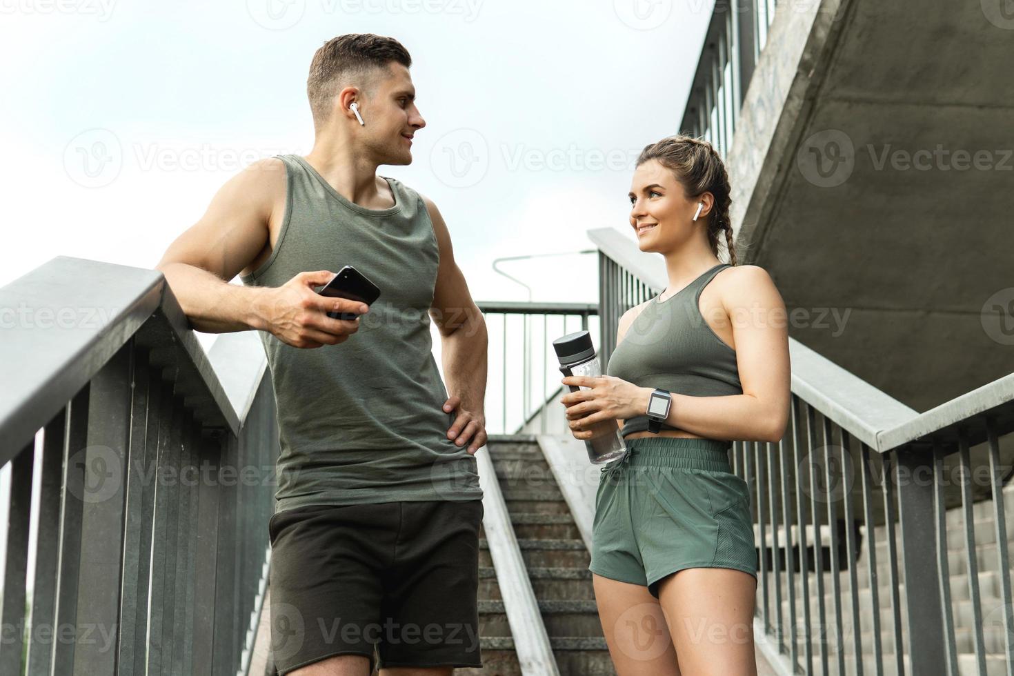 Young sportive couple relaxing after fitness workout photo