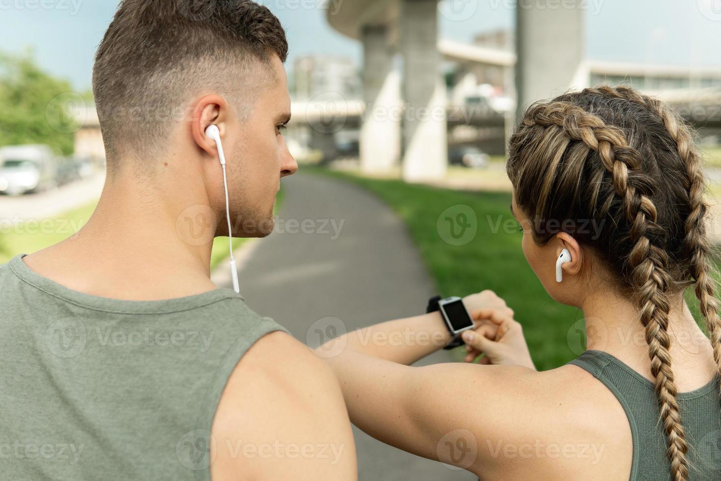Confident athletic couple ready for street workout photo
