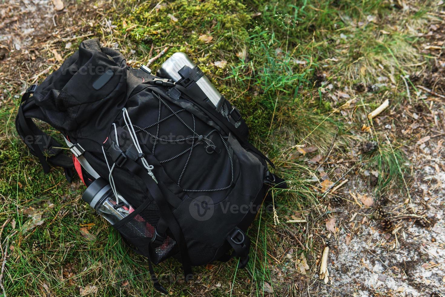 Traveler's backpack with supplies on the ground photo