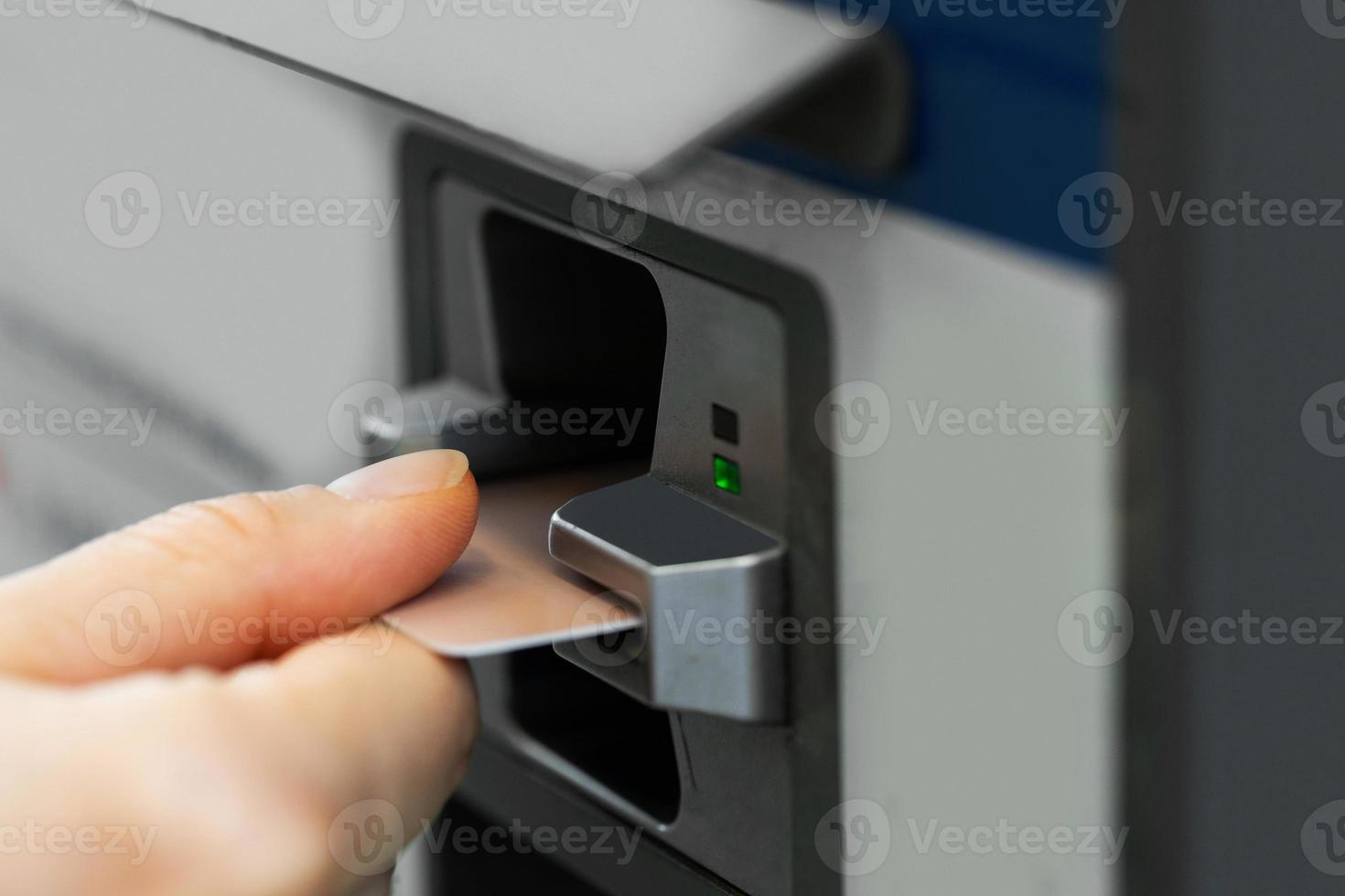 Female hand with a credit card and ticket vending machine photo