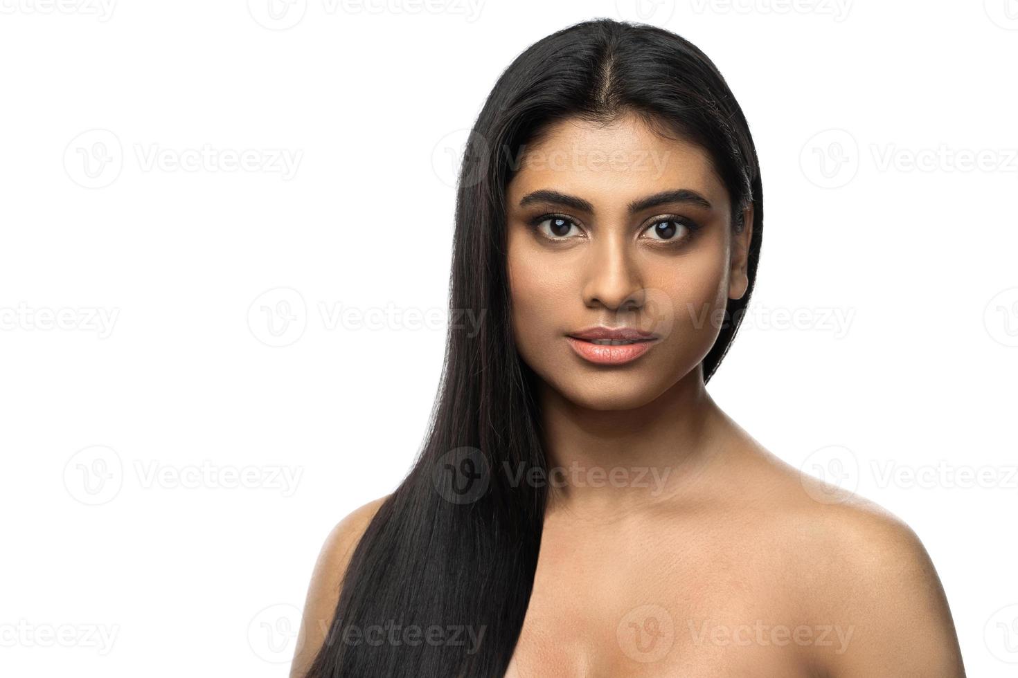 mujer india con piel suave y cabello largo y negro sobre fondo blanco foto