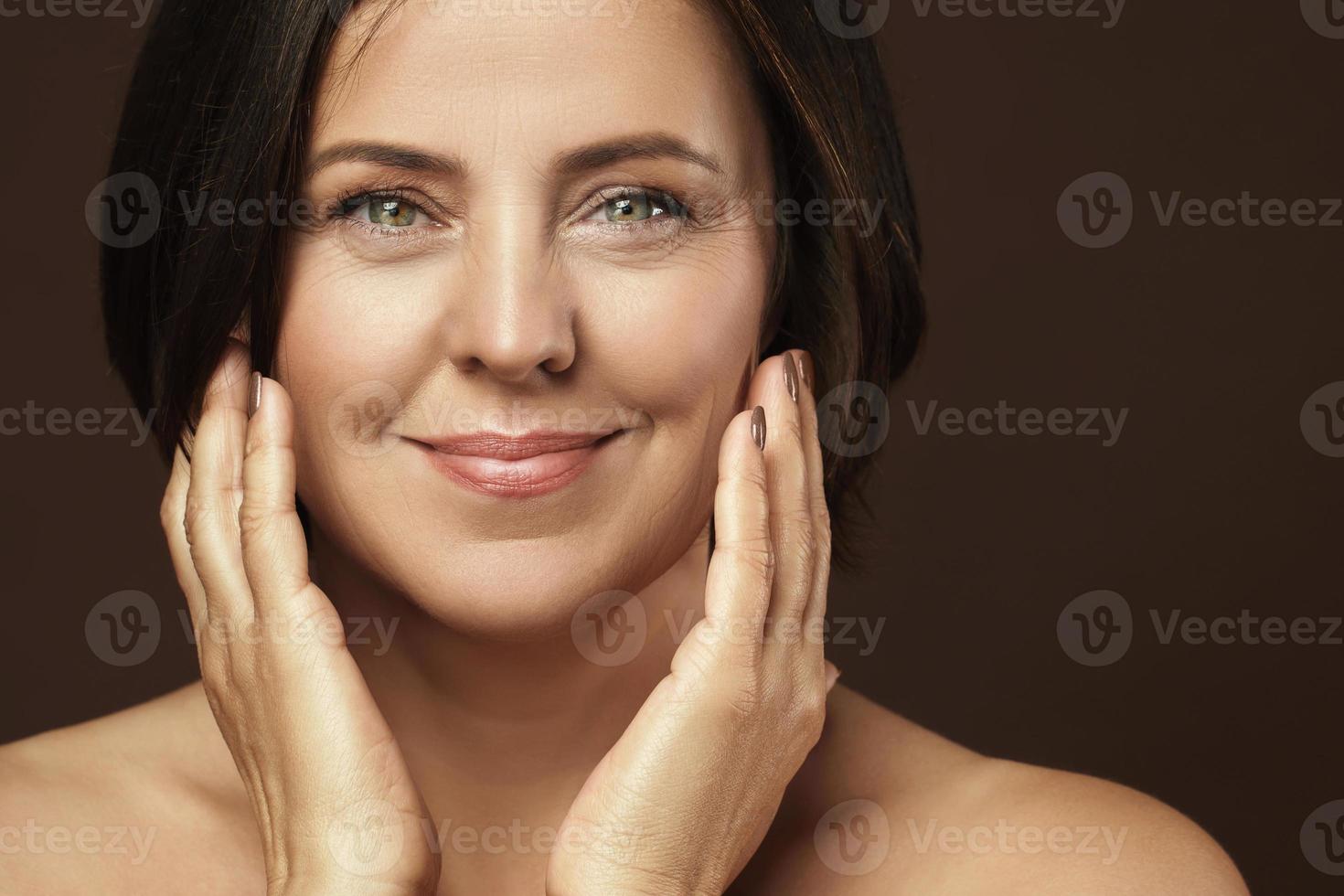 Beautiful middle aged woman with clean wrinkled skin photo