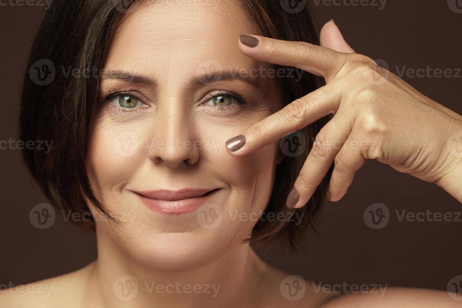 Beautiful middle aged woman with clean wrinkled skin photo