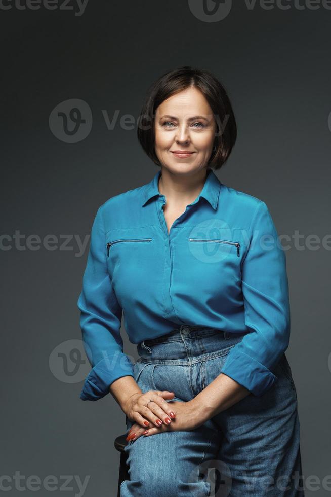 Beautiful middle aged woman wearing blue shirt photo
