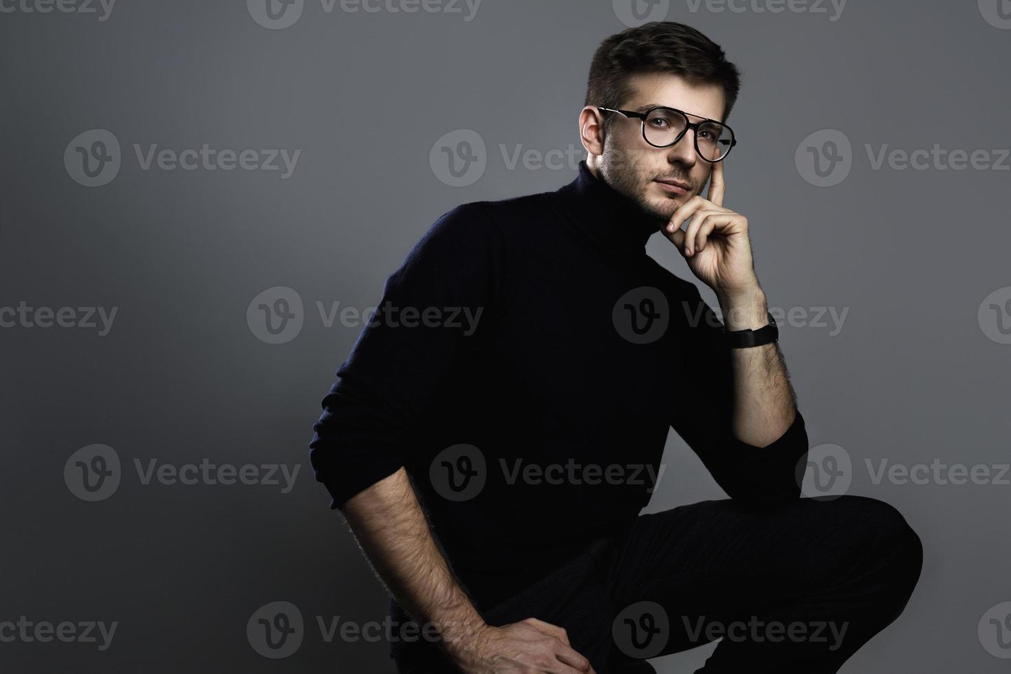 Young intelligent man wearing turtleneck and eyeglasses photo