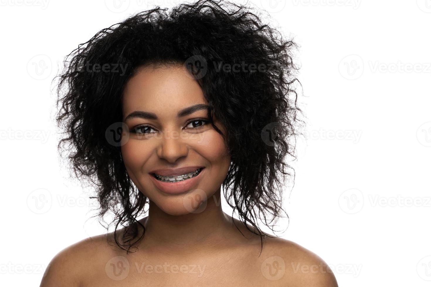 Portrait of smiling black woman with dental braces on her teeth photo