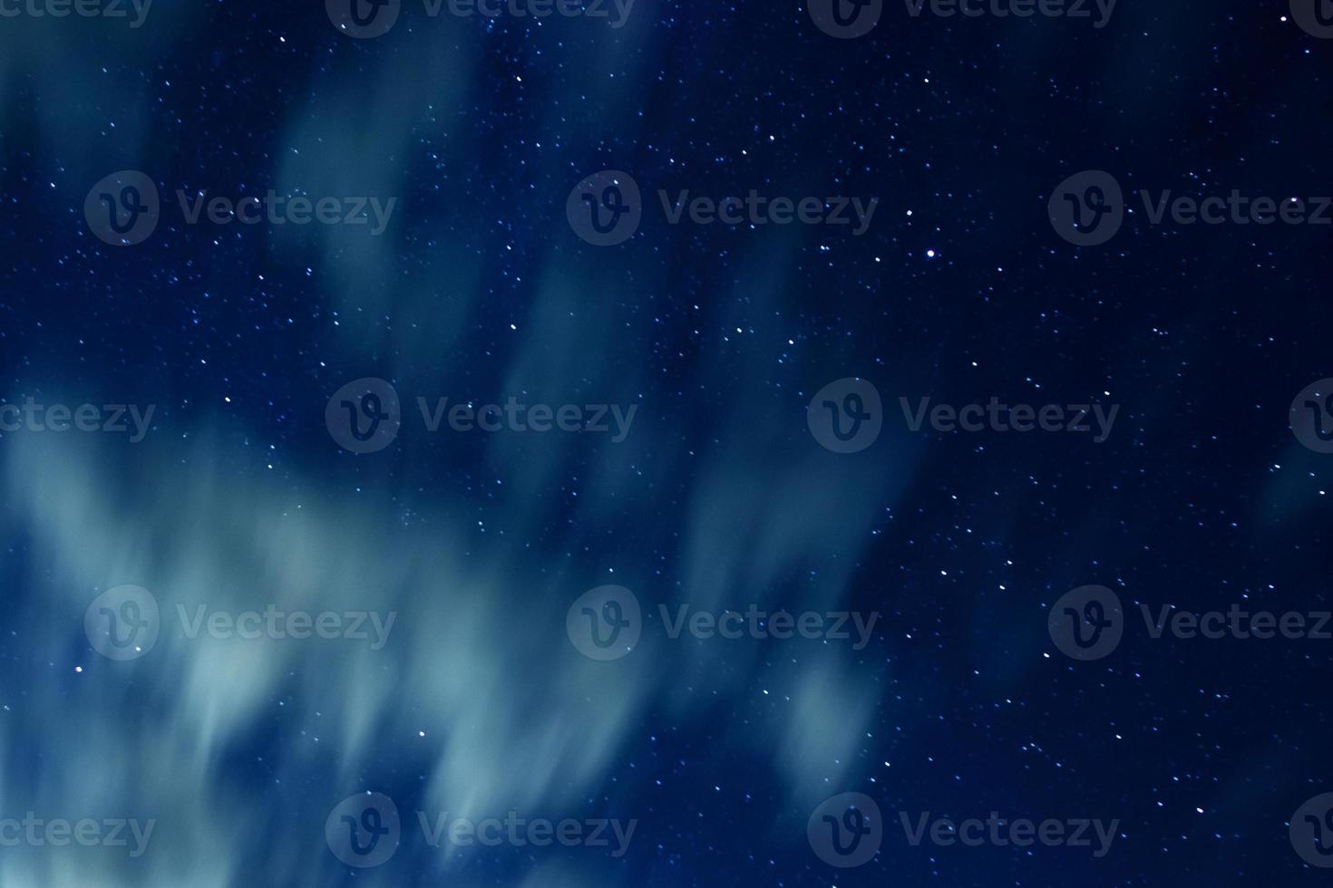 Night sky with stars and clouds in motion photo