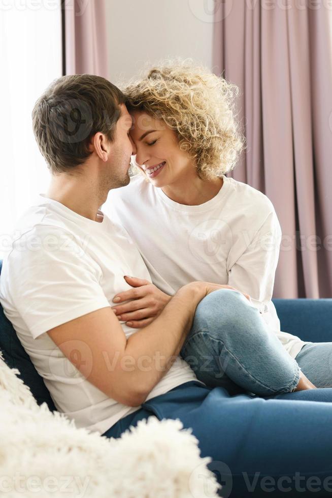 Young and happy couple relaxing at home photo