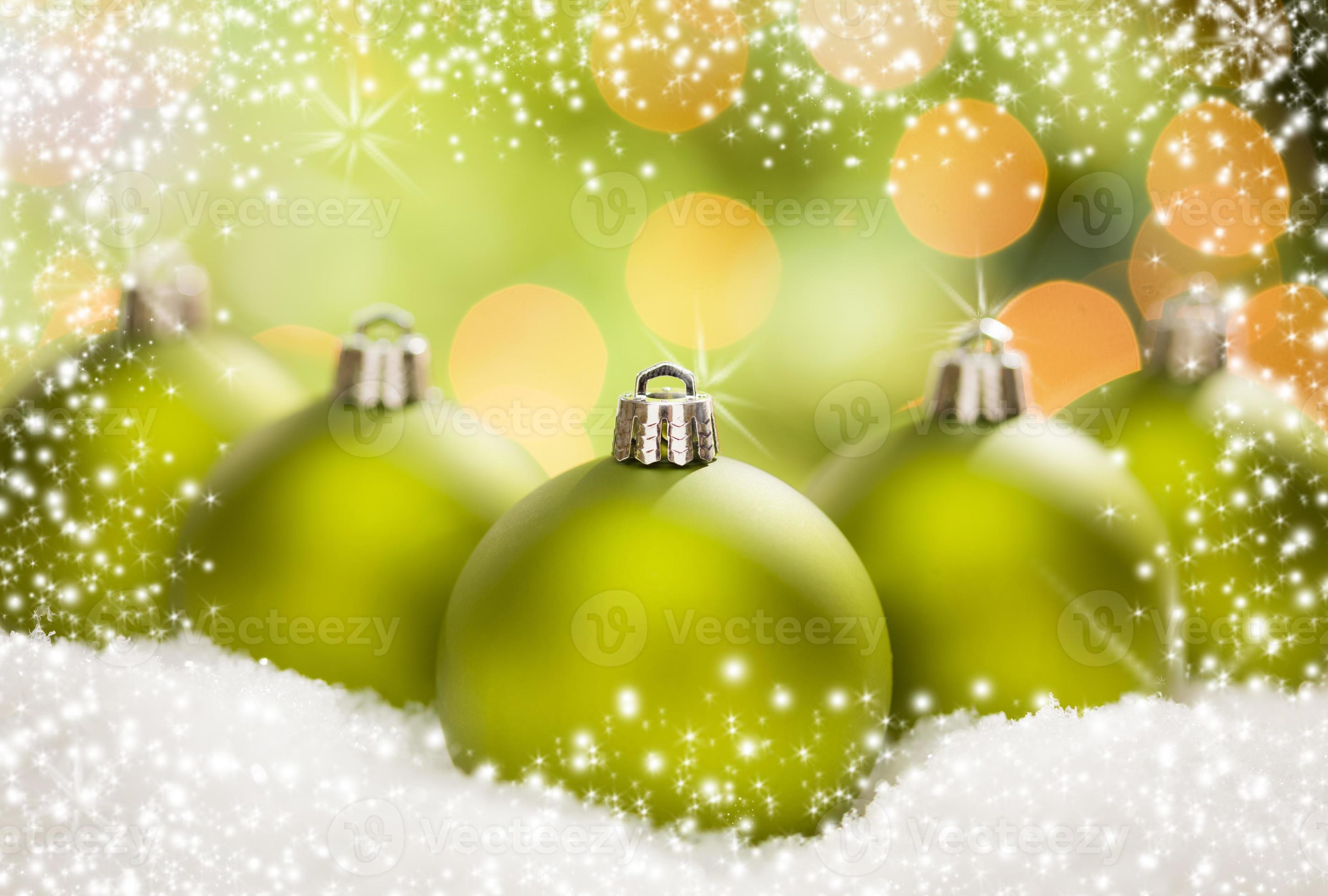 Green Christmas Ornaments on Snow Over an Abstract Background 16292234