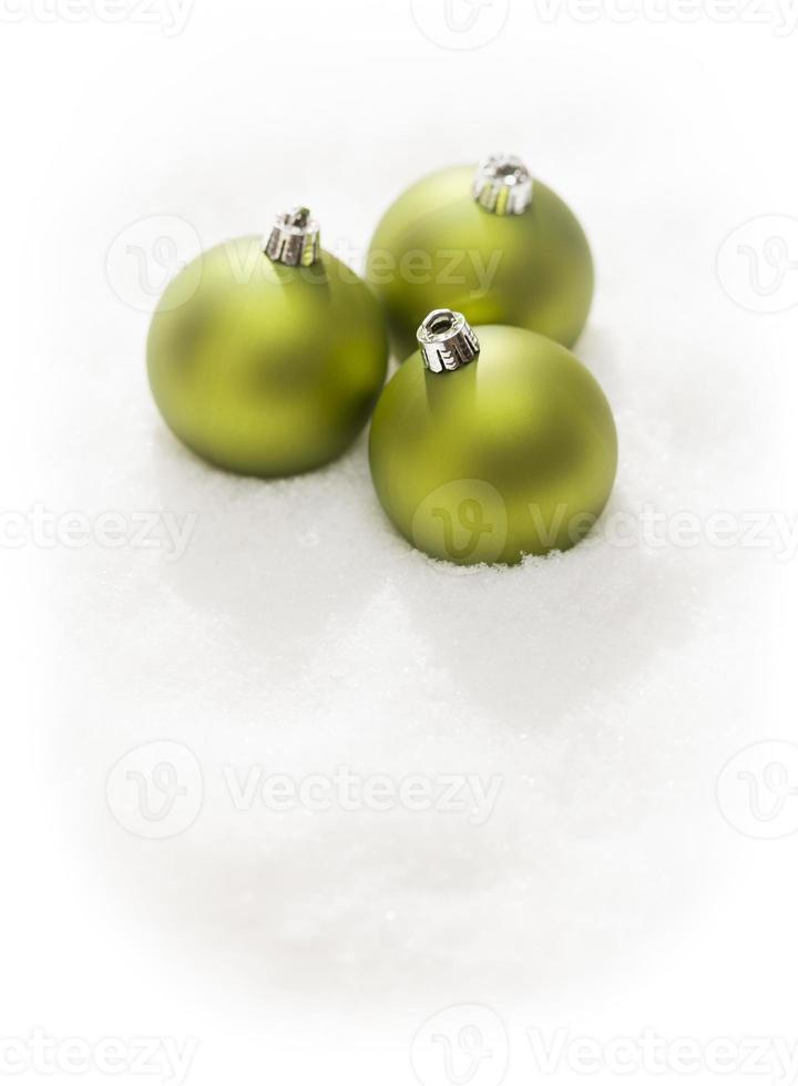Green Christmas Ornaments on Snow Flakes Isolated on White photo