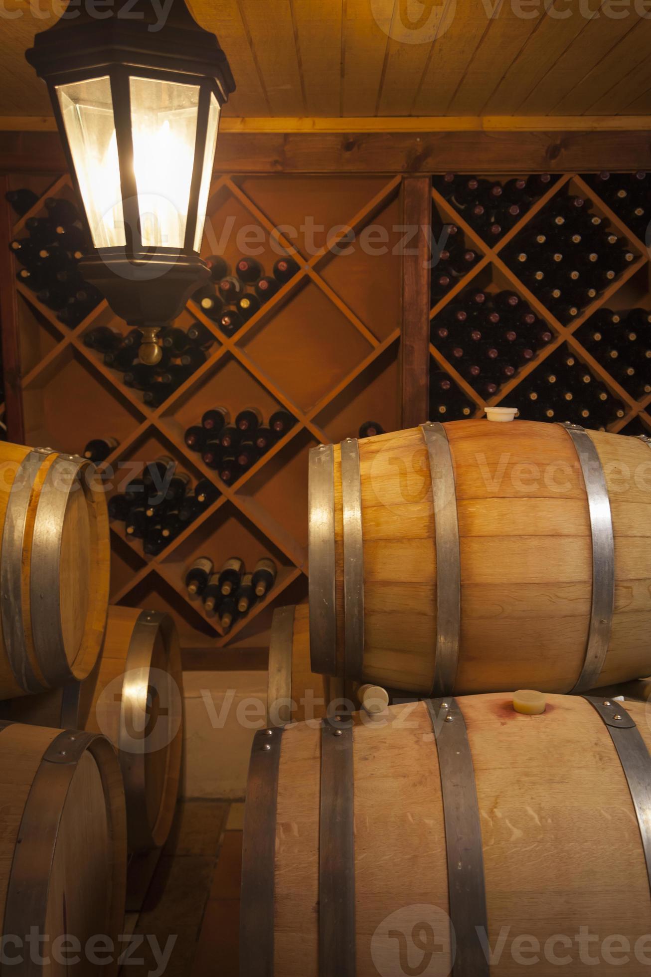 Wine Barrels and Bottles in Cellar 16292336 Stock Photo at Vecteezy
