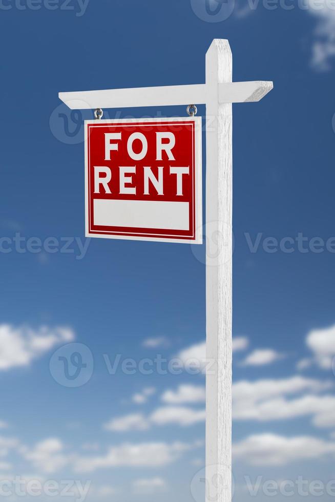 Left Facing For Rent Real Estate Sign on a Blue Sky with Clouds. photo