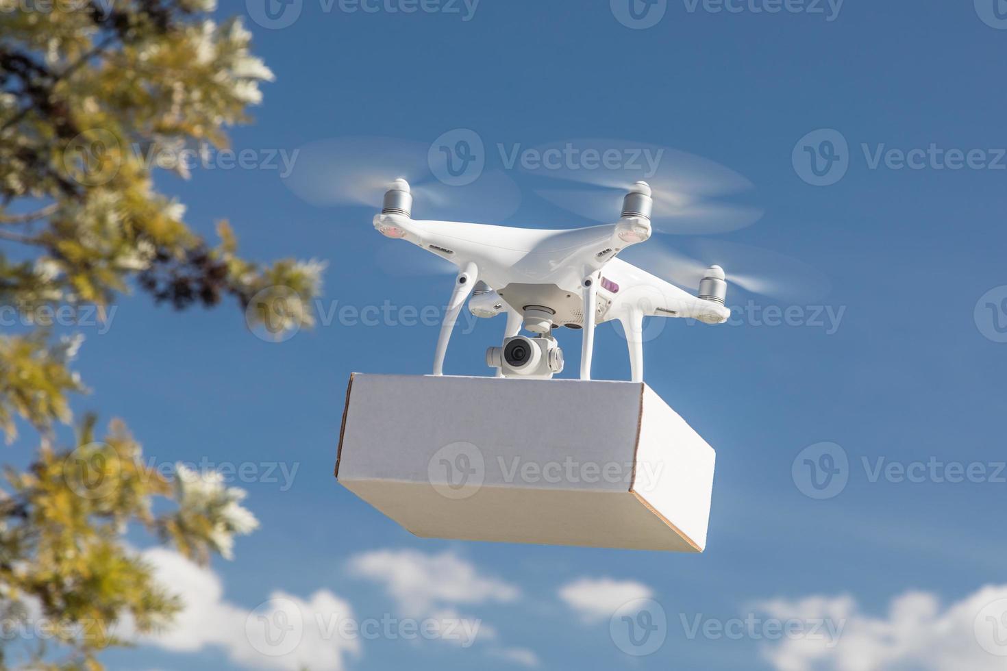 Unmanned Aircraft System Drone Carrying Blank Package In The Air. photo