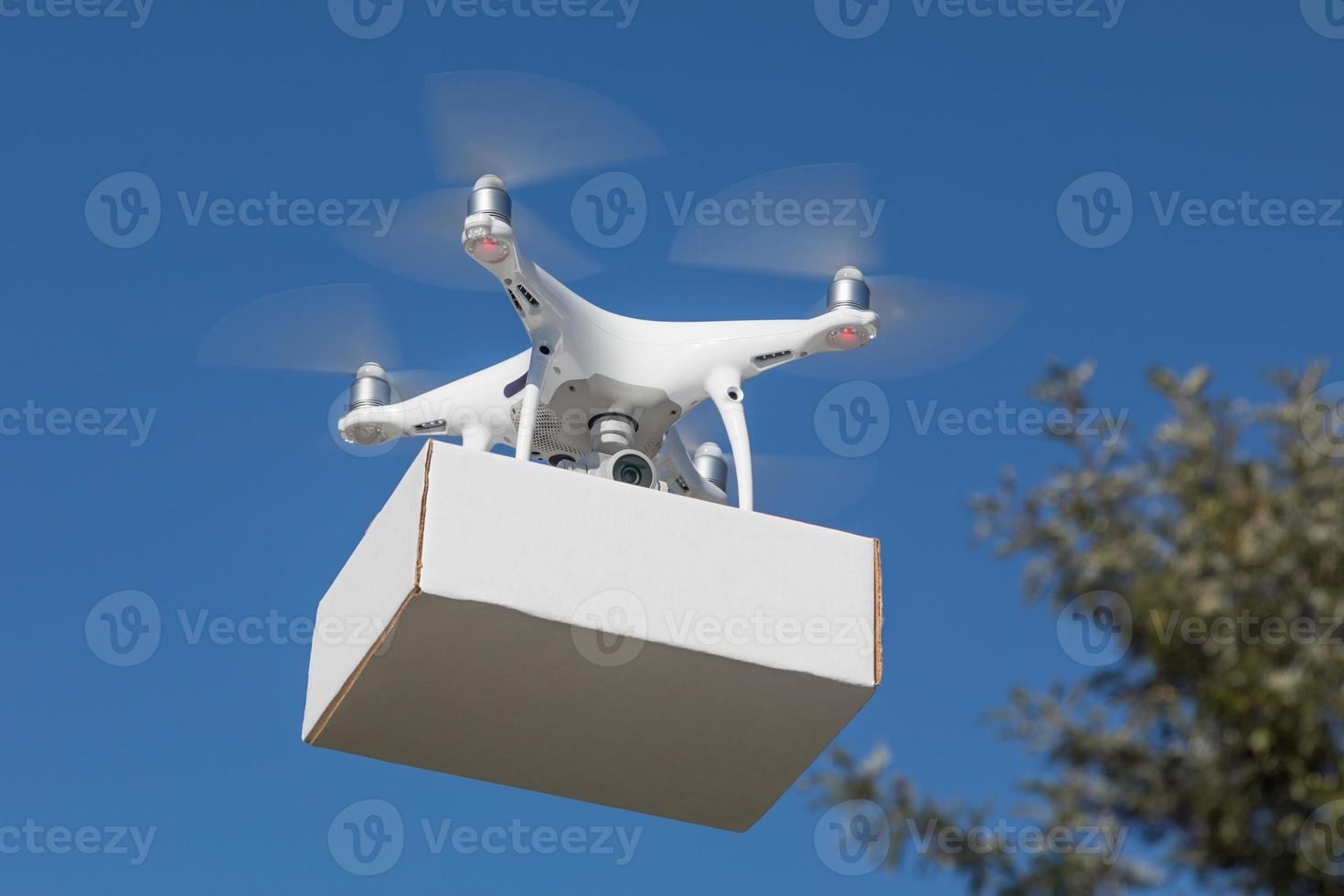 Unmanned Aircraft System Drone Carrying Blank Package In The Air. photo