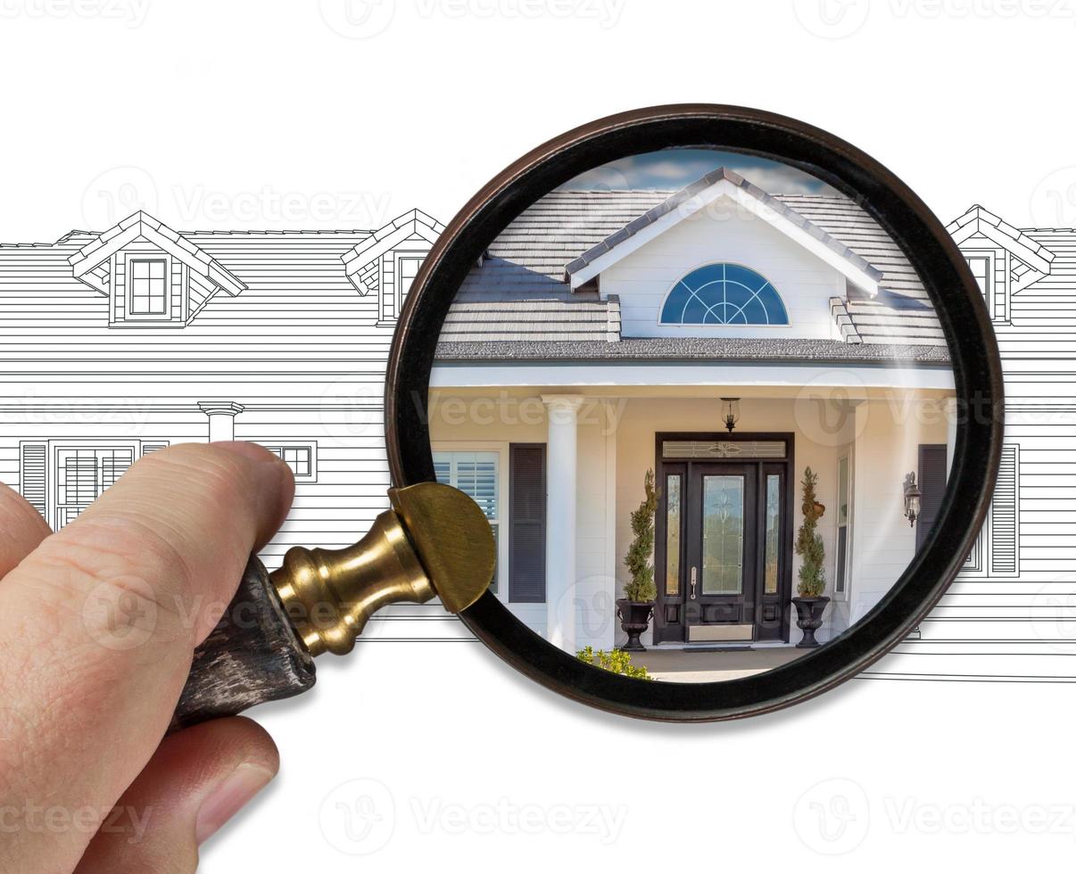 Hand Holding Magnifying Glass Revealing Finished House Build Over Drawing photo