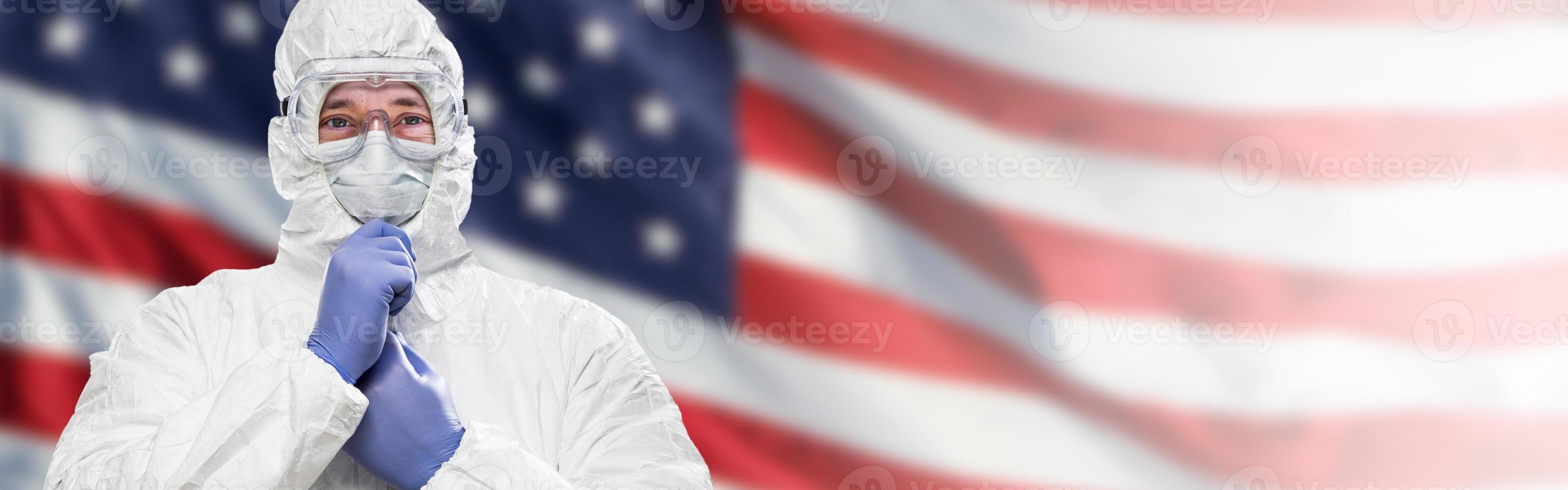Doctor or Nurse Wearing Medical Personal Protective Equipment Against The American Flag Banner photo