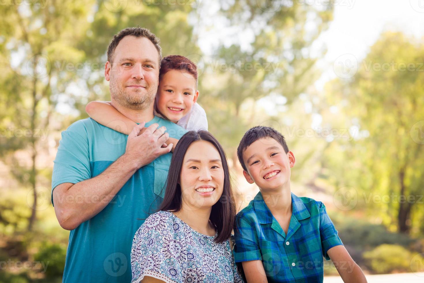Outdoor portrait of biracial Chinese and Caucasian family. photo