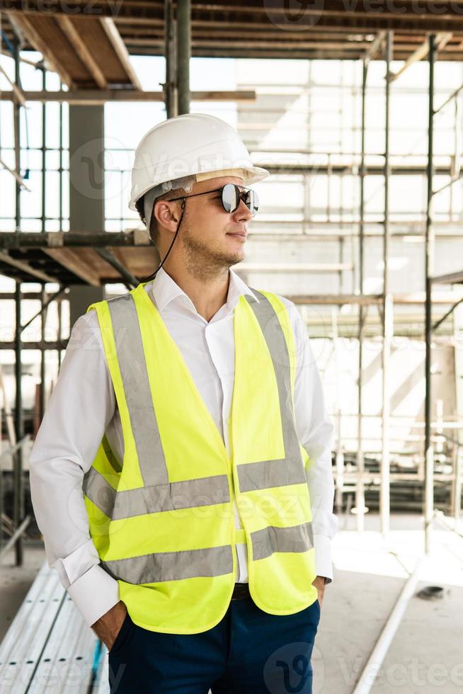 Arquitecto con chaleco de seguridad en un sitio de construcción foto