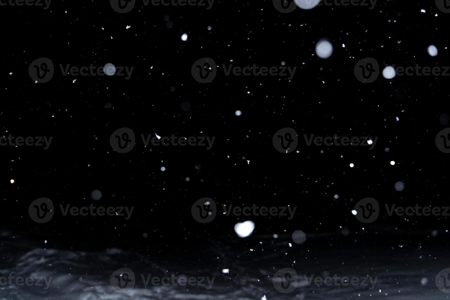Element for winter design or overlay. Real snow over black background. photo