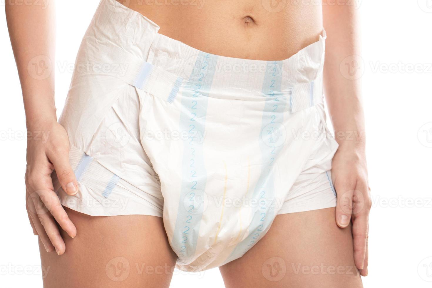 Woman wearing adult diaper against white background. photo