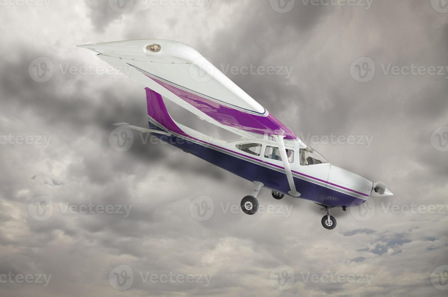 Cessna 172 With Smoke Coming From Engine Against Gray Sky photo