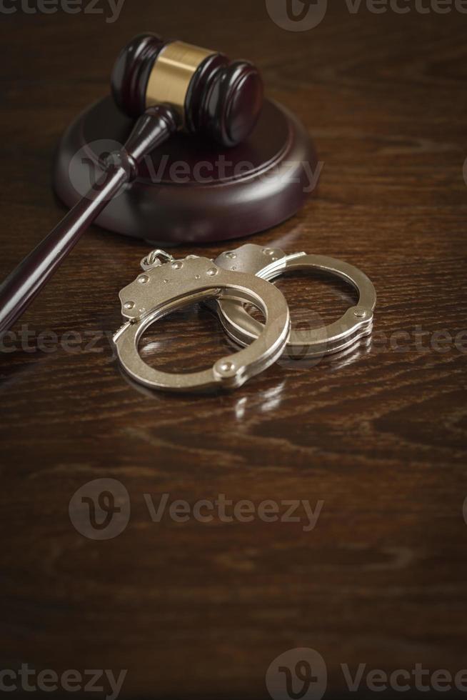 Gavel and Pair of Handcuffs on Table photo